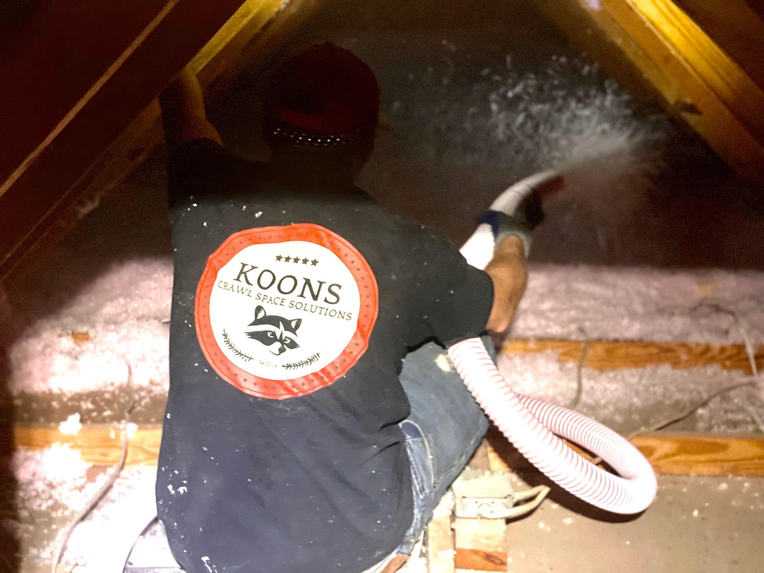 One of the crew in a Koons shirt, working overhead.