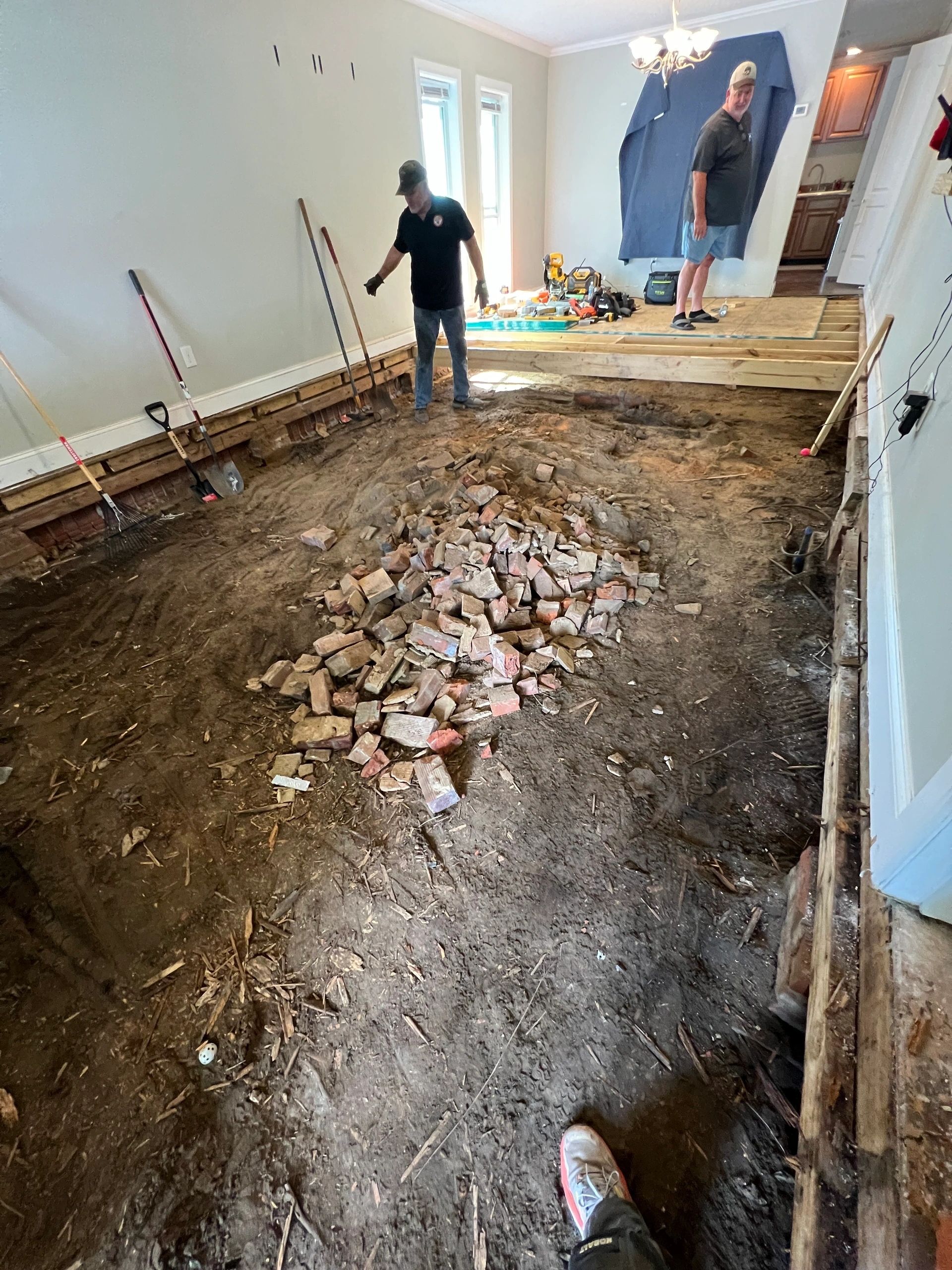 Two of the crew working over an opened floor.