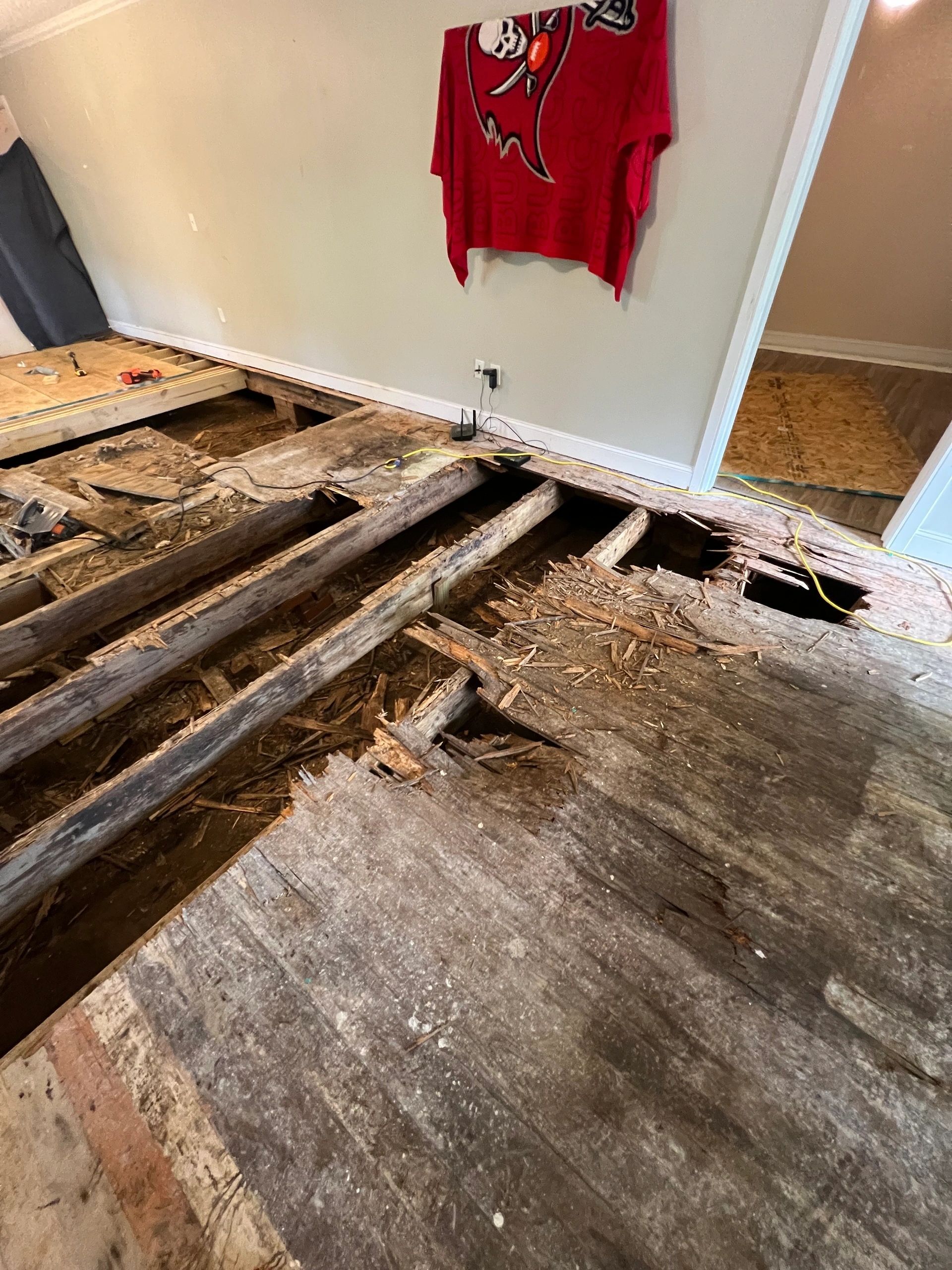 Floorboards away, the joists exposed the length of the room.