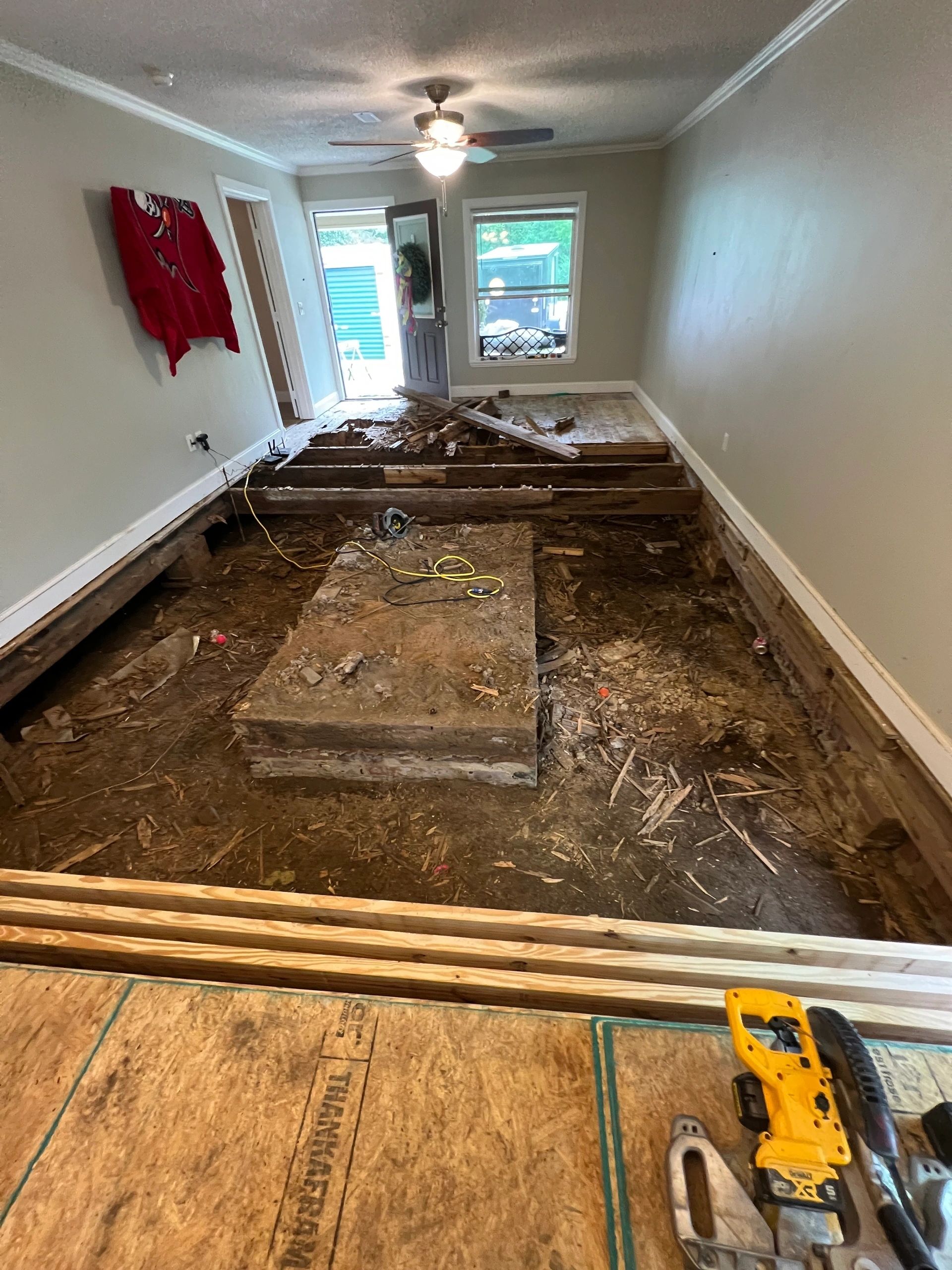 The floor opened up mid-job, tools and offcuts still on the deck.