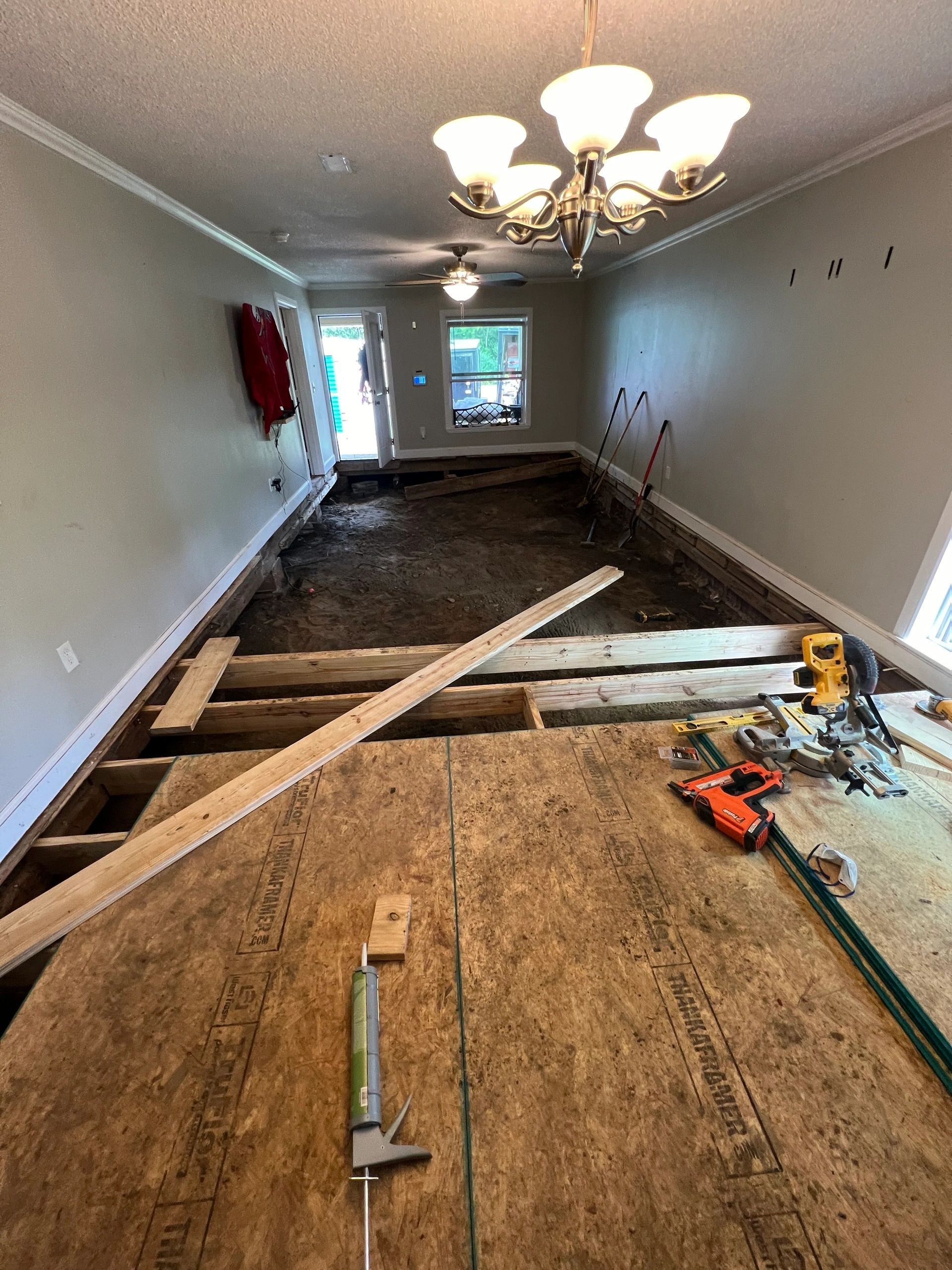 A level across the new subfloor before the finish goes on.
